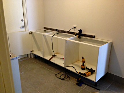 fitting kitchen base units to wall
